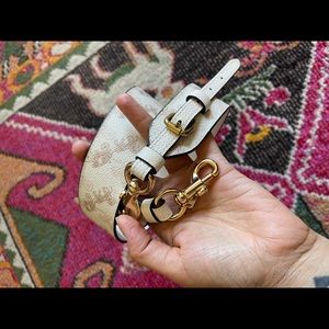 Coach novelty Strap With Horse And Carriage Print. Brass and gold hardware